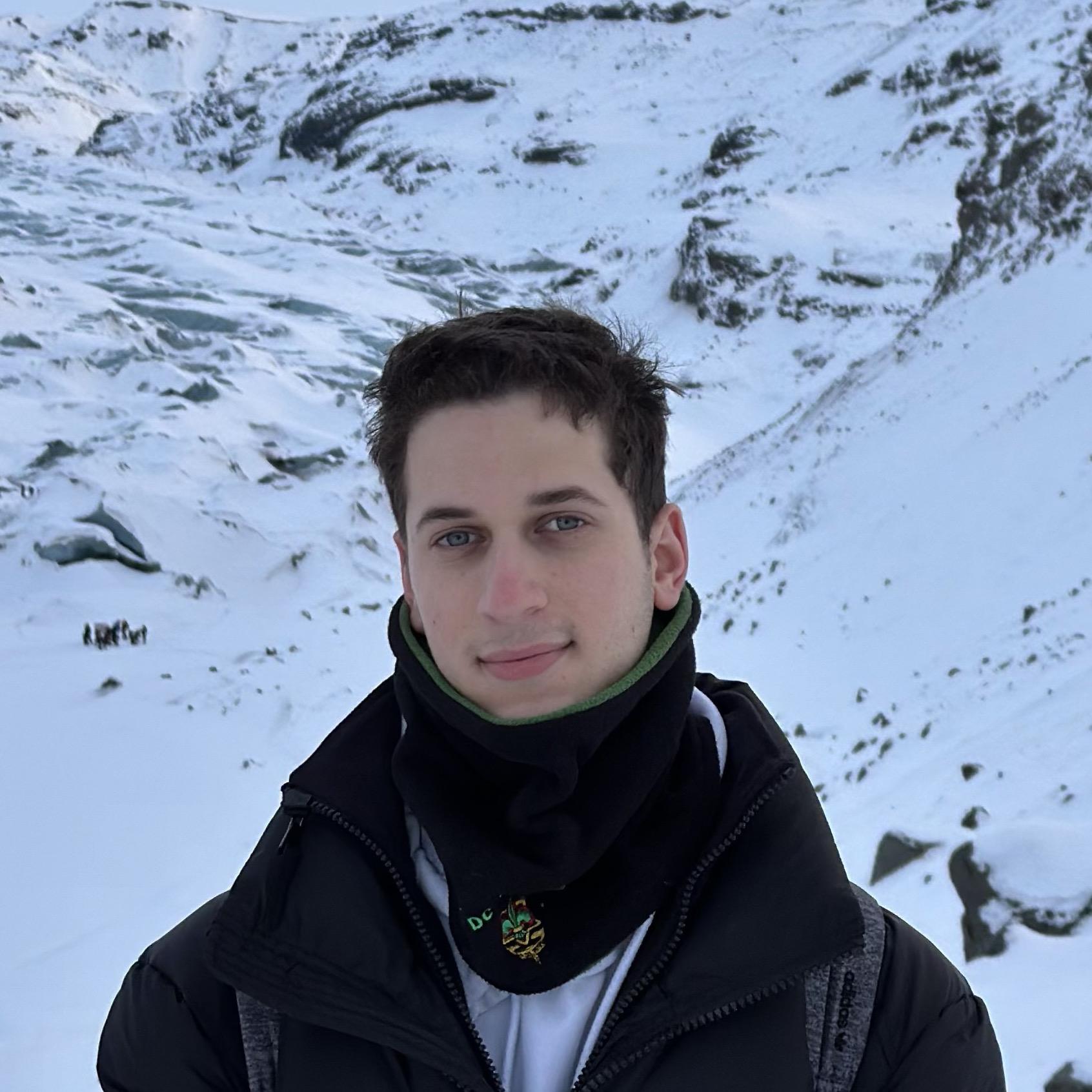 image of a person in front of snow covered mountain