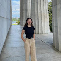 image of a person standing with monument columns visible behind