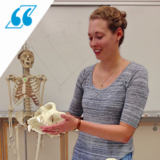 Meagan Vakiener, a PhD Student in Human Paleobiology, holds a primate skull