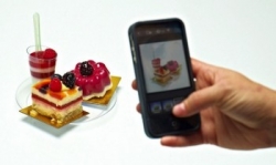 Phone taking a picture of a dessert tray